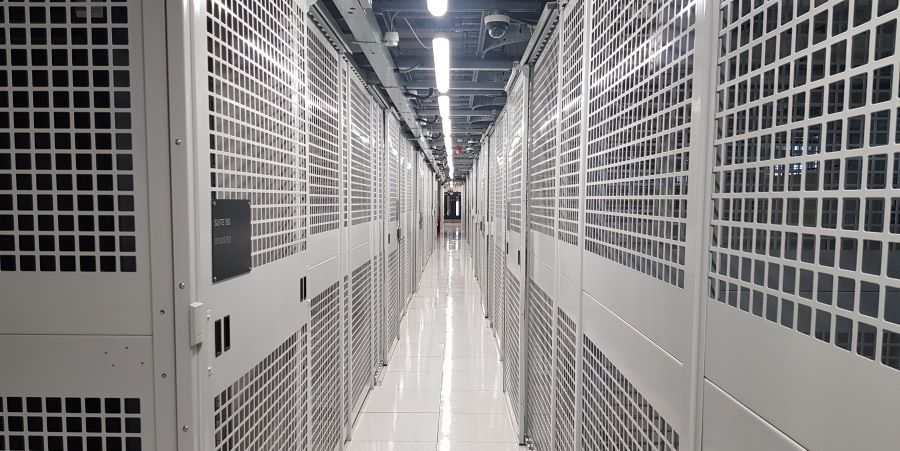 Inside the UKNode Manchester data centre — caged server racks.