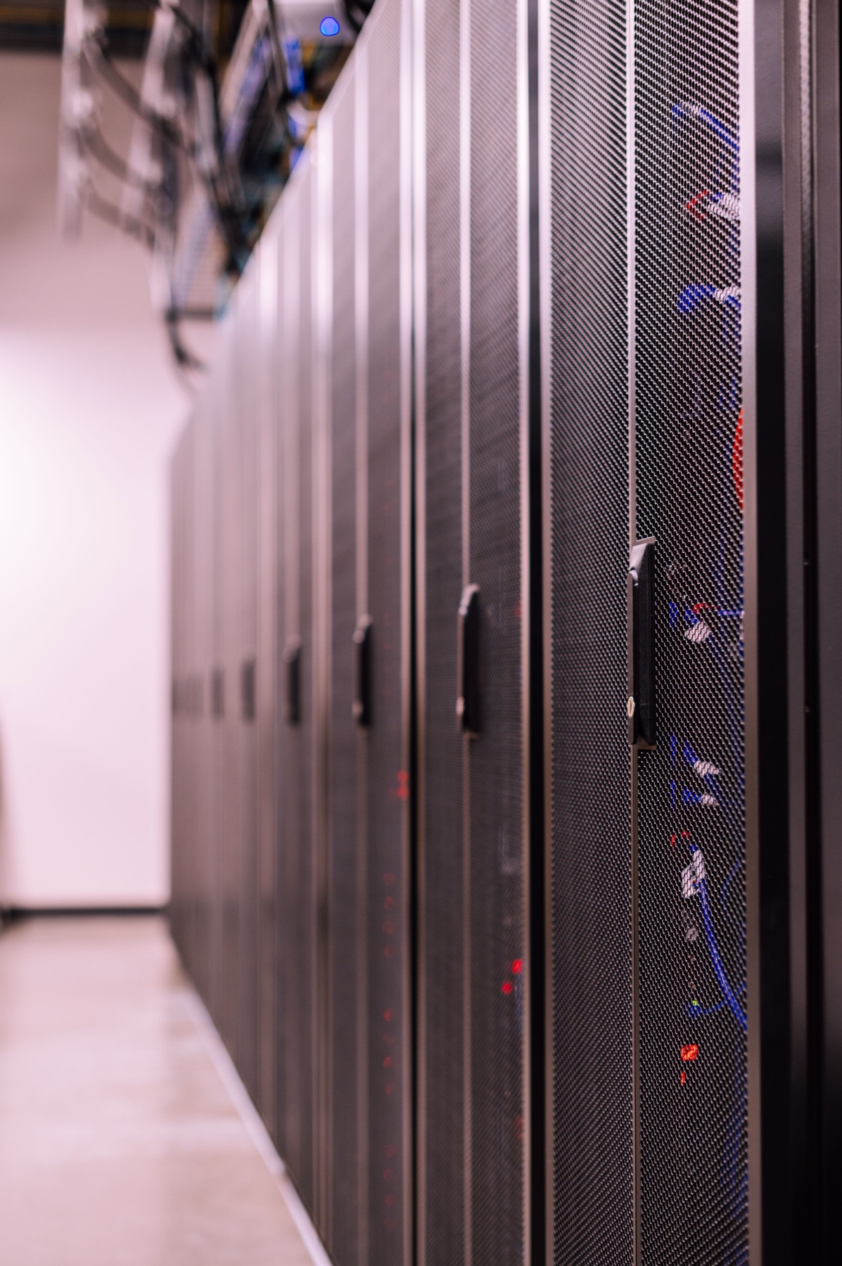 Row of locked rack cabinets with structured cabling in the Manchester data centre.